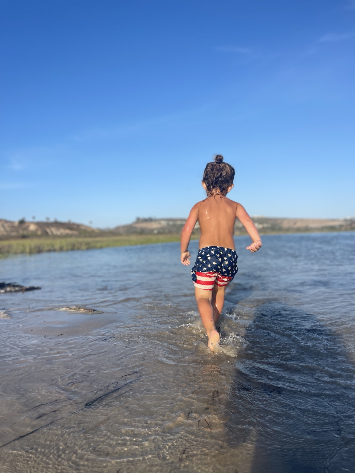 Reference photograph of a child walking into the water
